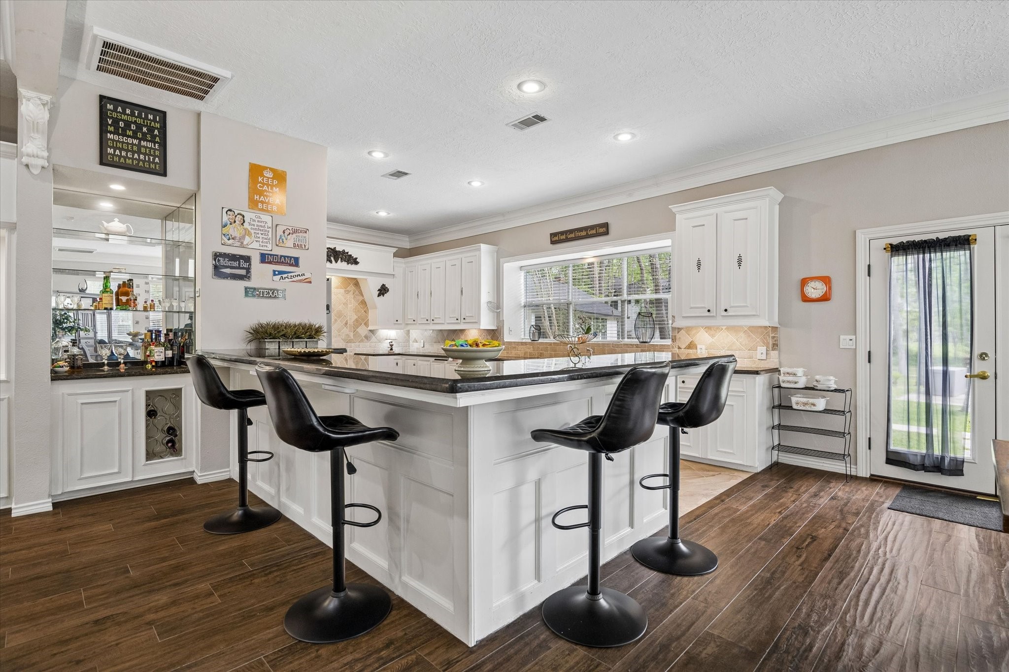 502 Monitor Park Conroe, TX 77302 - Photo 7 of 26 Designed for gathering, the kitchen offers bar seating for slow mornings and a dry bar for easy evenings.