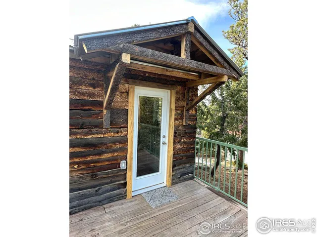 a view of a house with wooden deck front of house
