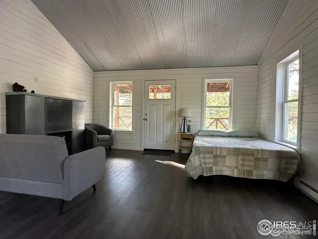 a living room with a bed furniture and a window