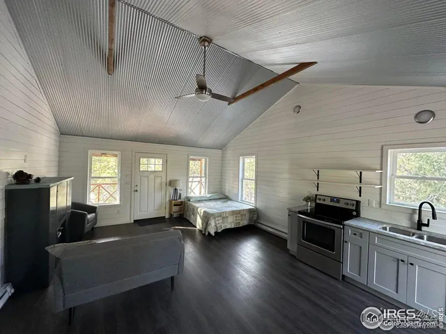 a kitchen with granite countertop a sink and cabinets
