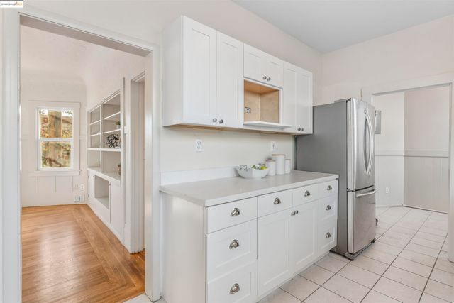 a kitchen with cabinets and wooden floor