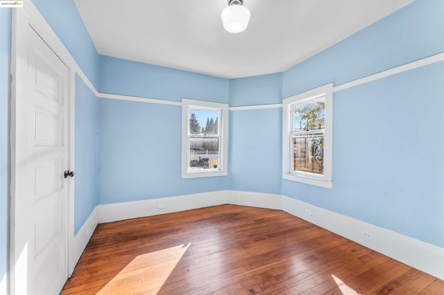 a view of a room with wooden floor and windows