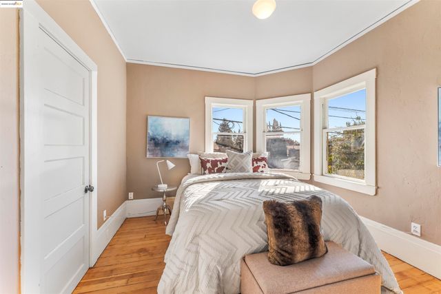 a bed sitting in a bedroom next to a window