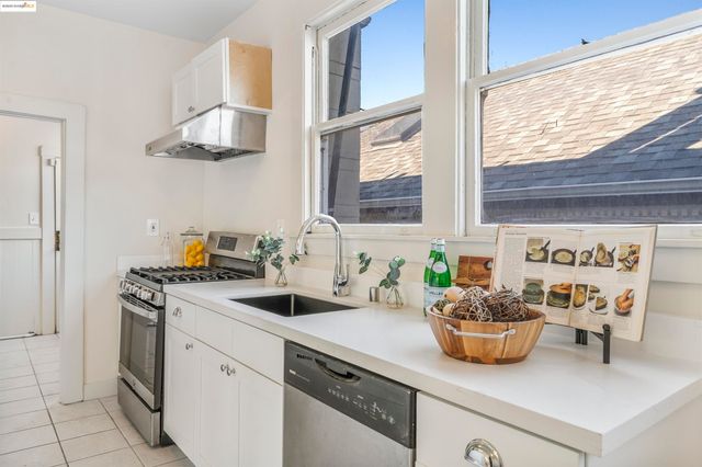 a kitchen with a sink a stove and cabinets