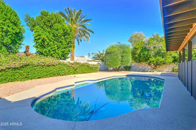 a view of a swimming pool with a yard