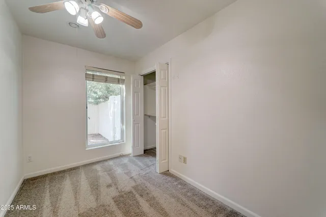 an empty room with stairs and windows