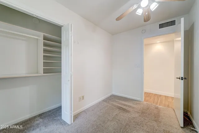 a view of an empty room with a fireplace