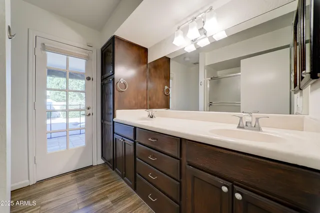 a bathroom with a double vanity sink and a mirror