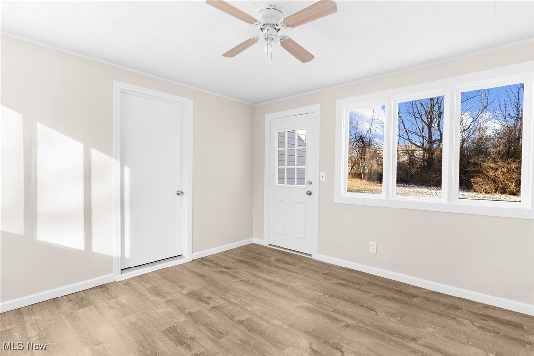 3441 Bell Wick Road Hubbard, OH 44425 - Photo 5 of 22 Spare room featuring ceiling fan, crown molding, and light hardwood / wood-style floors