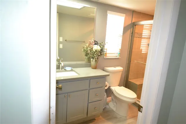 a bathroom with a sink a toilet and shower