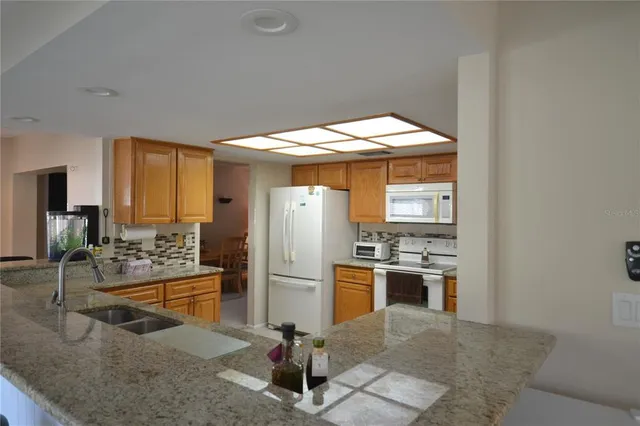 a kitchen with kitchen island a counter top space and stainless steel appliances