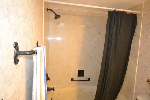 a view of a room that has a bed and a window in it