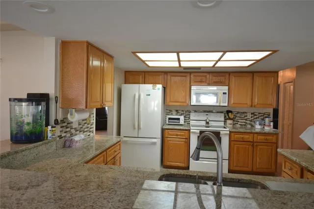 a kitchen with refrigerator and microwave