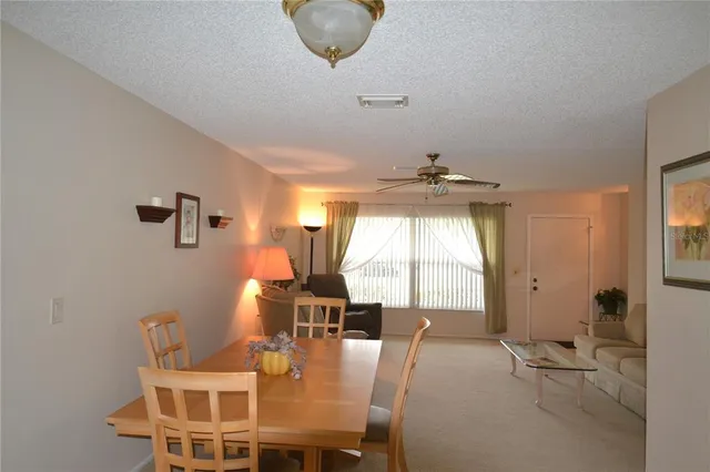 a dining room with furniture and window