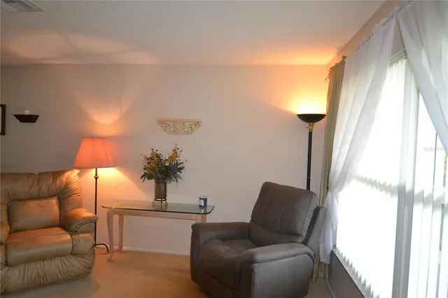 a living room with furniture and a lamp