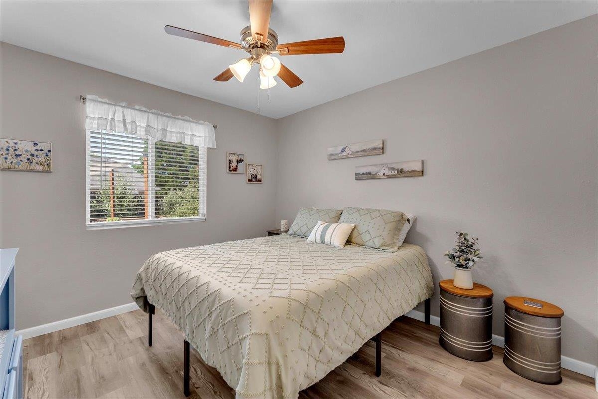 2110 Gentry Way Red Bluff, CA 96080 - Photo 20 of 47 a bedroom with a bed and a chandelier