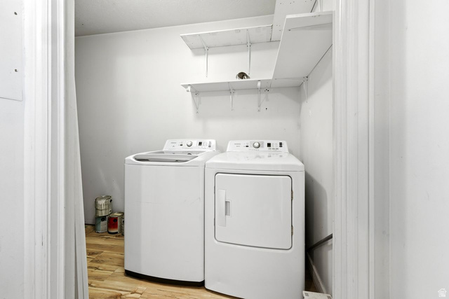 977 East 100 South Payson, UT 84651 - Photo 16 of 19 Laundry area featuring light wood-type flooring and washing machine and dryer
