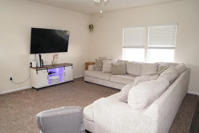 a living room with furniture and a flat screen tv