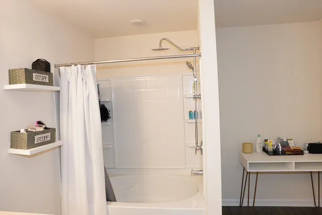 a bathroom with a shower and a window