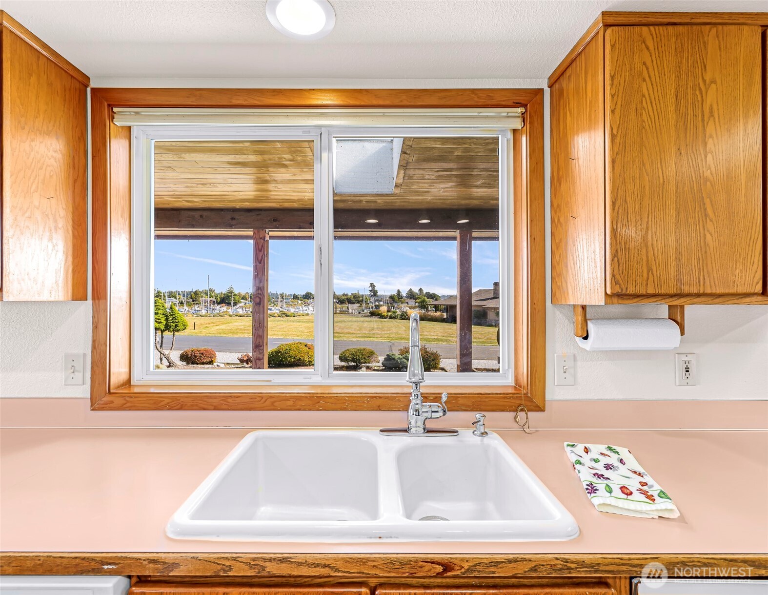 8059 Comox Road Blaine, WA 98230 - Photo 12 of 38 a view of a kitchen with kitchen island a large window and a sink