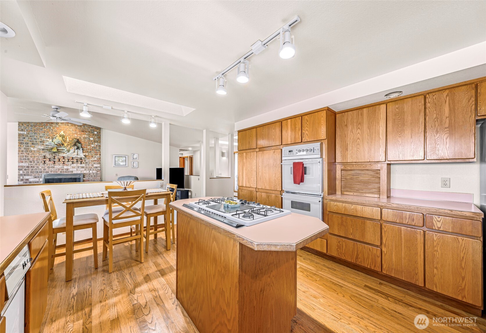 8059 Comox Road Blaine, WA 98230 - Photo 13 of 38 a open kitchen with stainless steel appliances granite countertop a stove a refrigerator a dining table and chairs with wooden floor