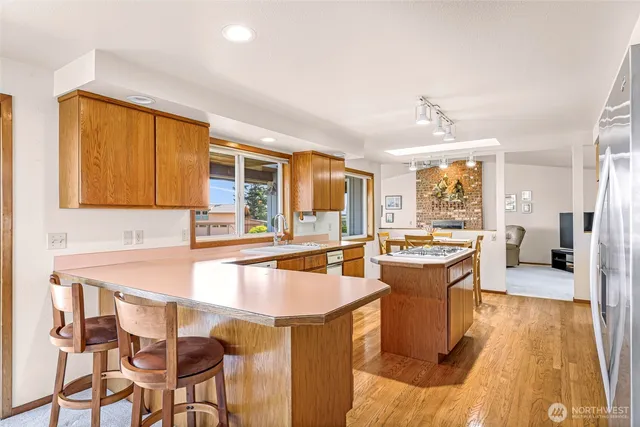 a kitchen with a table chairs sink and cabinets