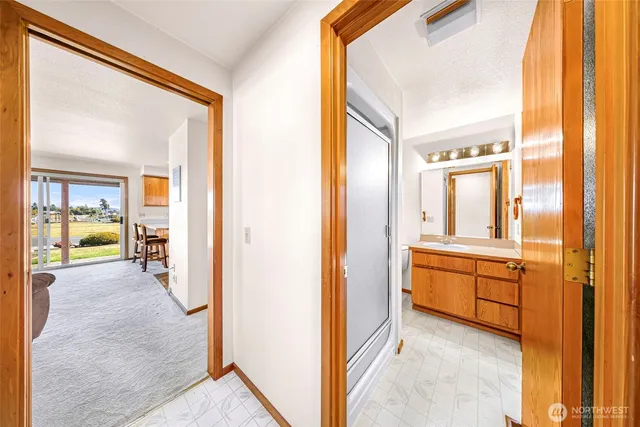 a view of a hallway with bathroom and bathroom
