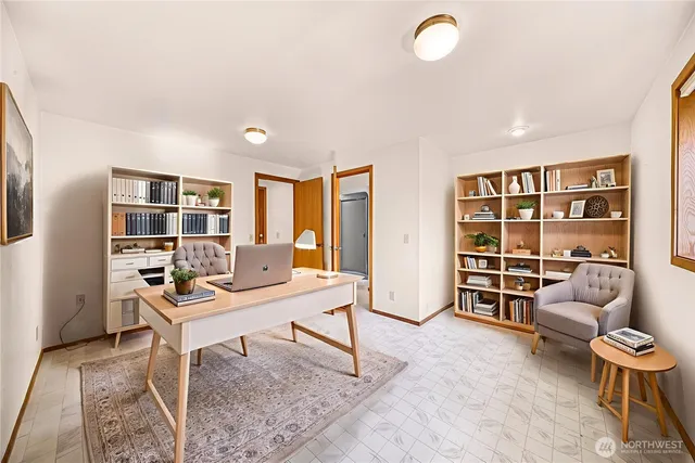 a view of a livingroom with workspace and a couch