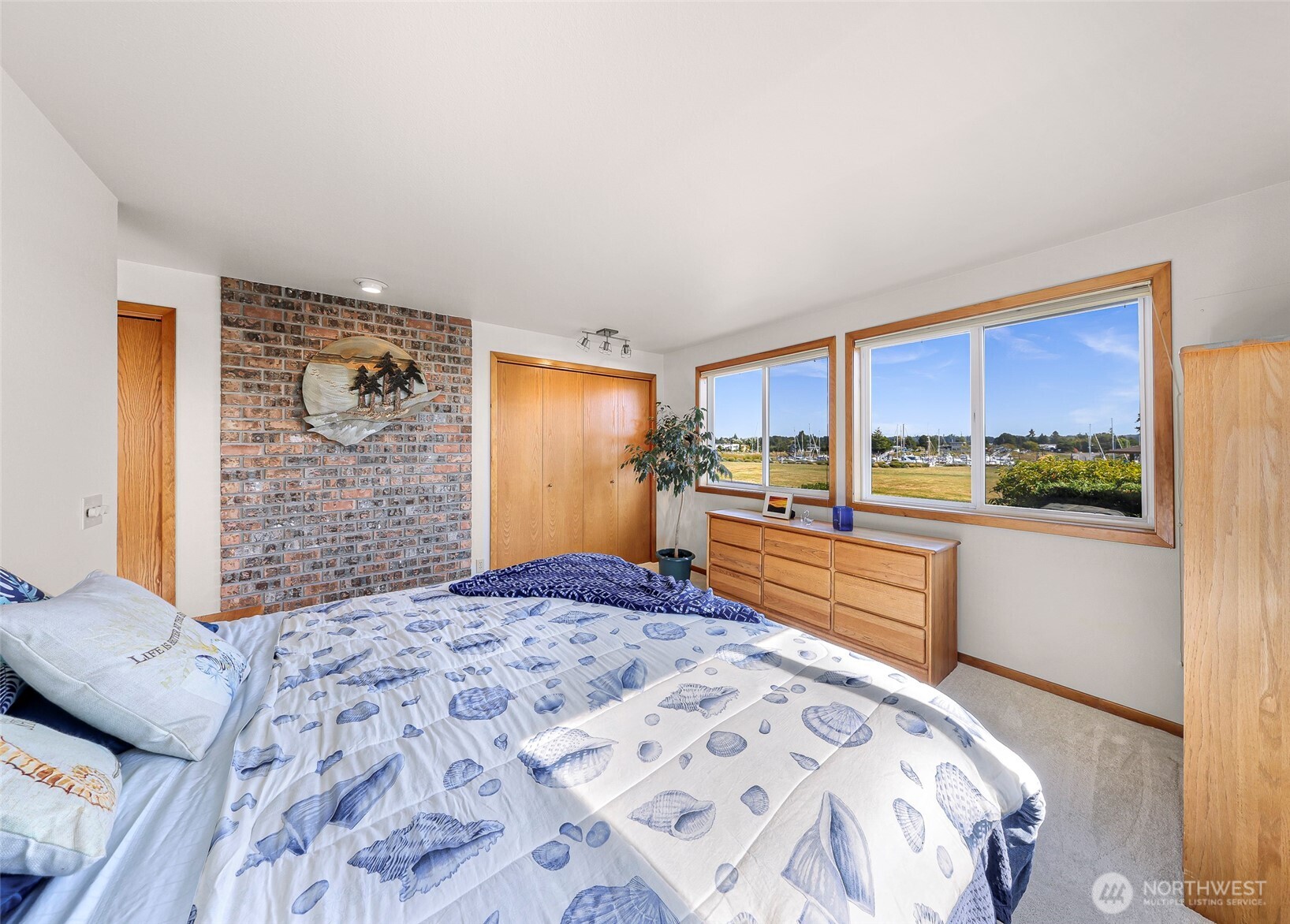 8059 Comox Road Blaine, WA 98230 - Photo 23 of 38 a bedroom with a large bed and a window