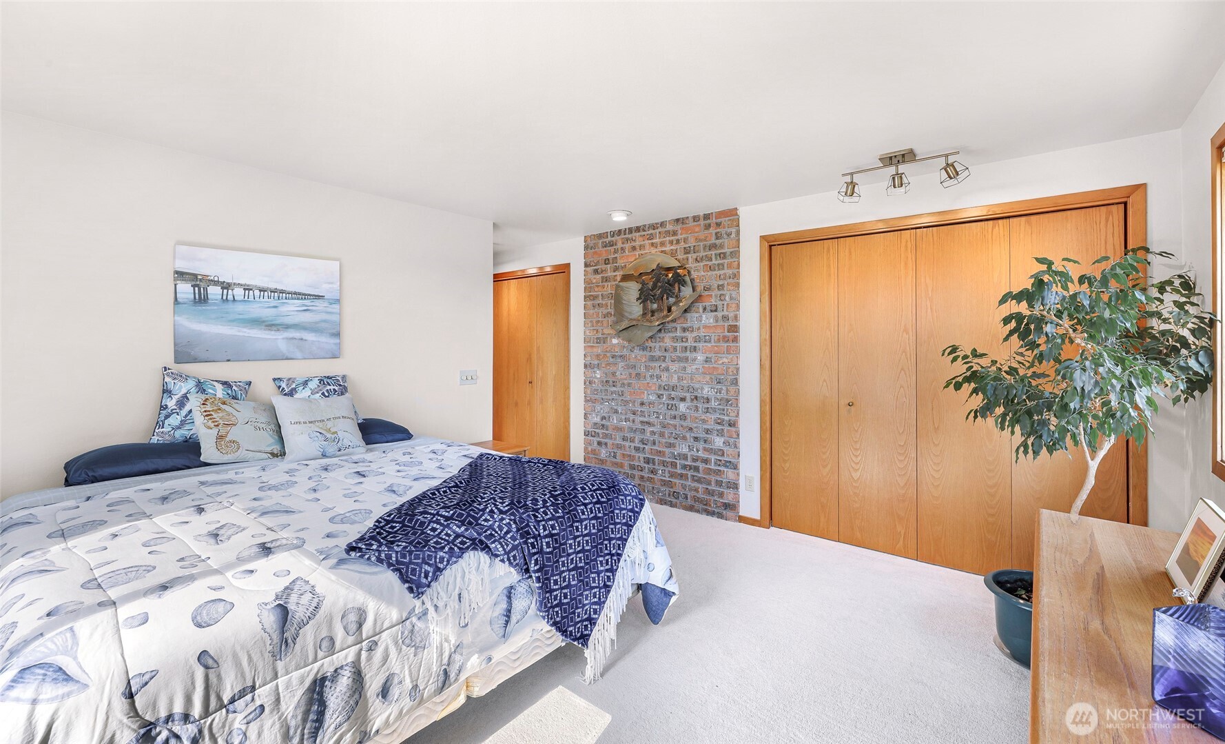 8059 Comox Road Blaine, WA 98230 - Photo 24 of 38 a bedroom with a bed and a potted plant