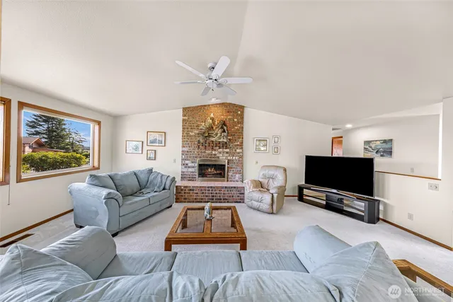 a living room with furniture a flat screen tv and a window