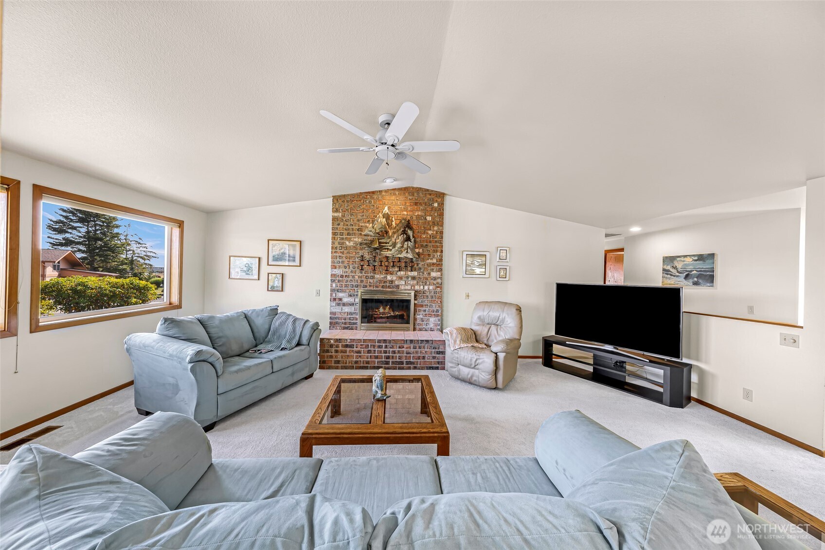8059 Comox Road Blaine, WA 98230 - Photo 9 of 38 a living room with furniture a flat screen tv and a window