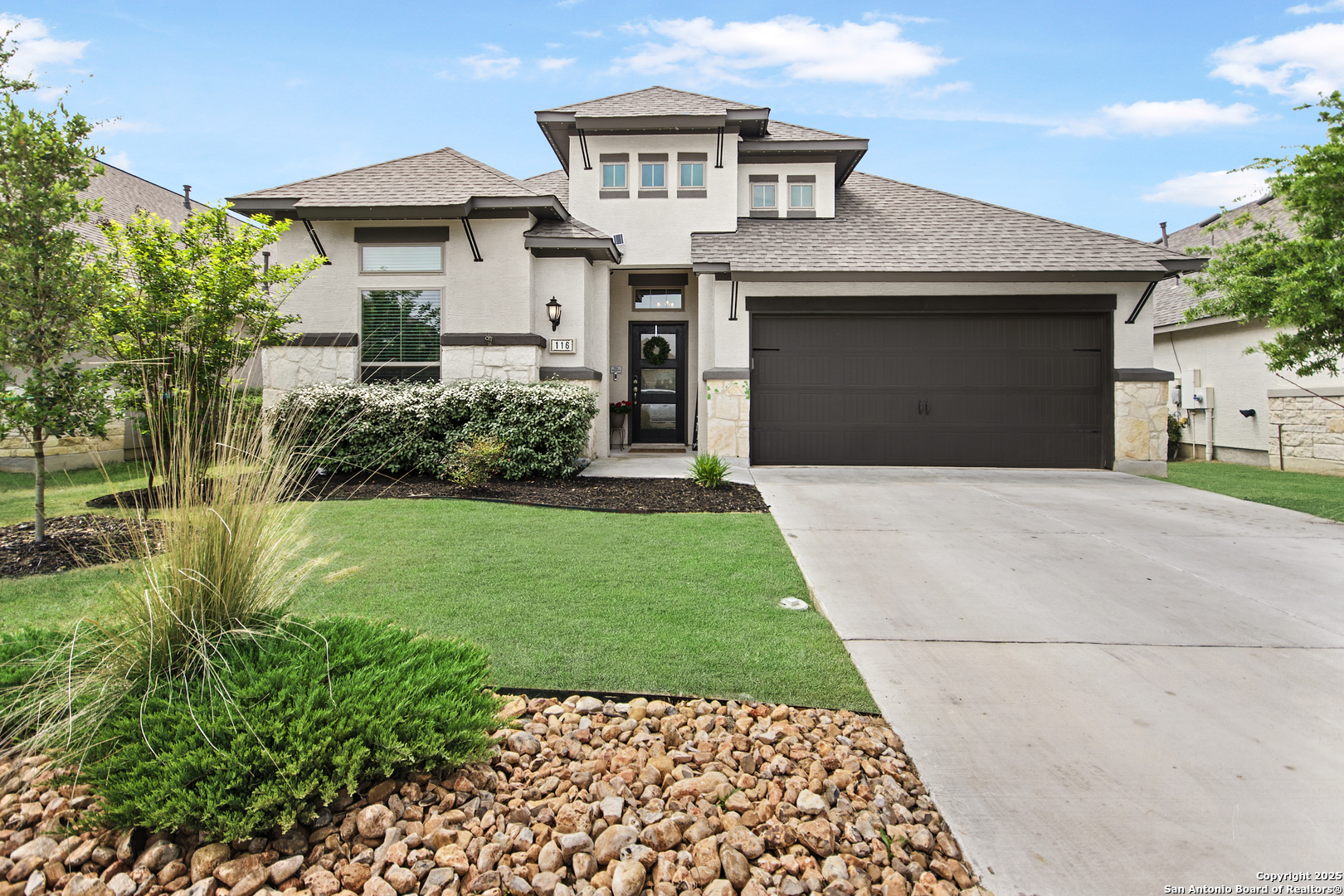 a front view of a house with a yard and garage