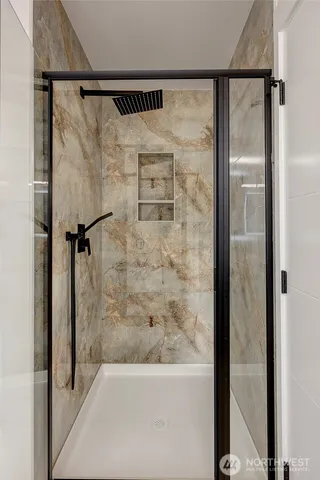 a bathroom with a shower and a bath tub