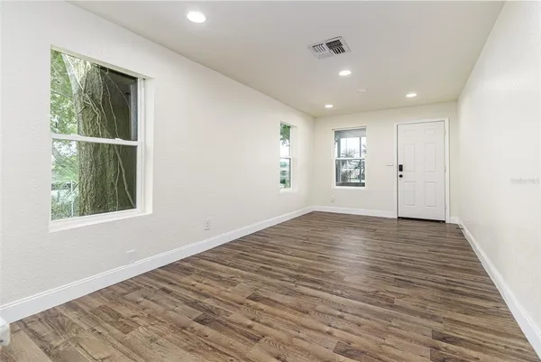 a kitchen with a sink wooden floor and window