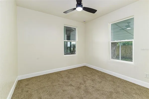 an empty room with windows and closet