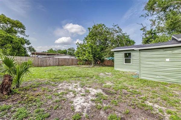 a view of a house with a backyard