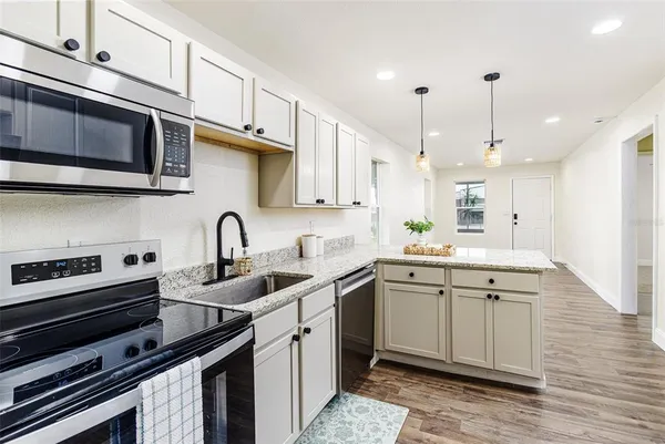 a view of a kitchen with a sink and a window