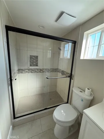 a bathroom with a toilet and a shower