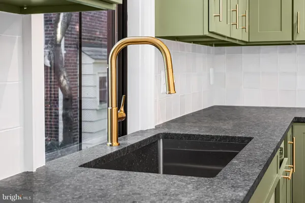a view of a kitchen with granite countertop cabinets
