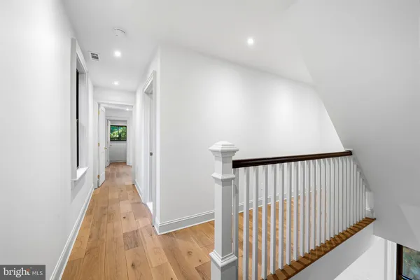a view of hallway with wooden floor