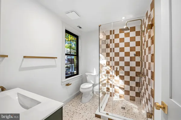 a bathroom with a sink toilet and shower