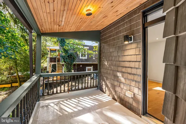 a view of a porch with wooden floor and outdoor space