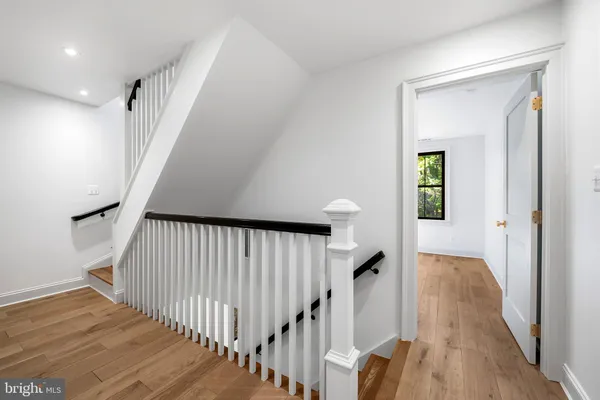a view of a hallway with wooden floor and entryway