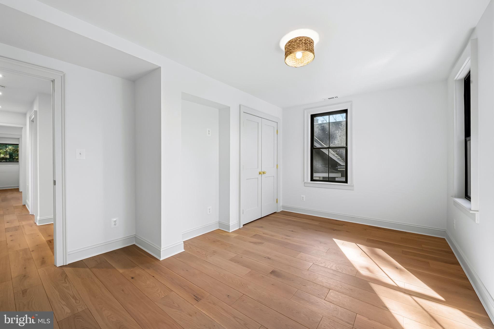 4629 Keswick Road Baltimore, MD 21210 - Photo 34 of 49 a view of an empty room with window and wooden floor