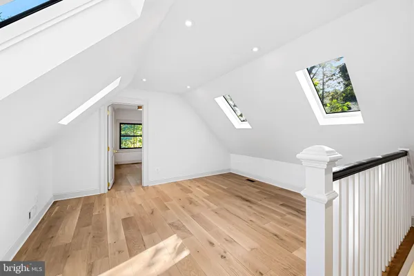 a view of empty room with wooden floor