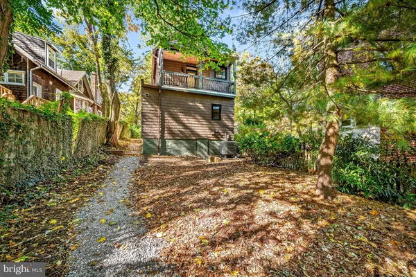 a view of backyard of house with green space