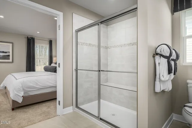 a spacious bedroom with a bed and a painting