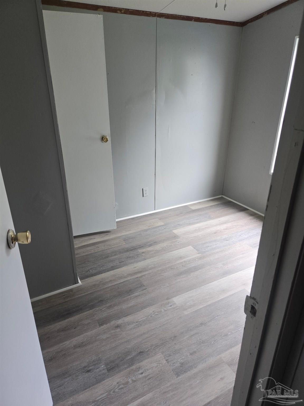 5675 Saufley Field Road, Unit 9 Pensacola, FL 32526 - Photo 3 of 15 a view of empty room with wooden floor