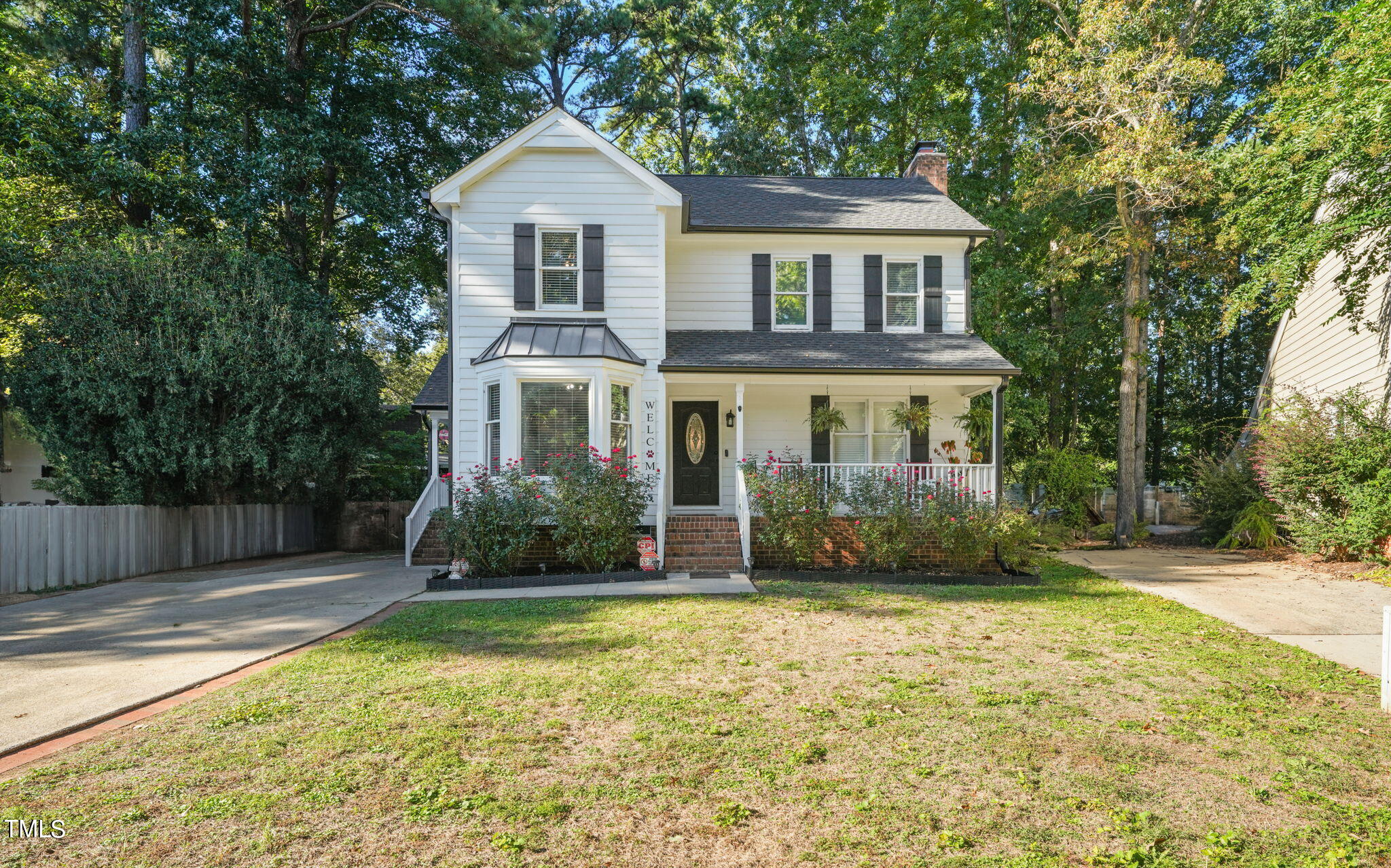 7125 Sandringham Drive Raleigh, NC 27613 - Photo 1 of 26 a front view of a house with a yard
